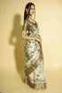 Vasthrlay Off White Abstract Print Polyester Saree With Antique Zari Border And Unstitched Blouse Piece