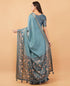 Vasthrlay Teal Blue Textured Polyester Saree With Kalamkari Floral Border And Ruched Unstitched Blouse Piece