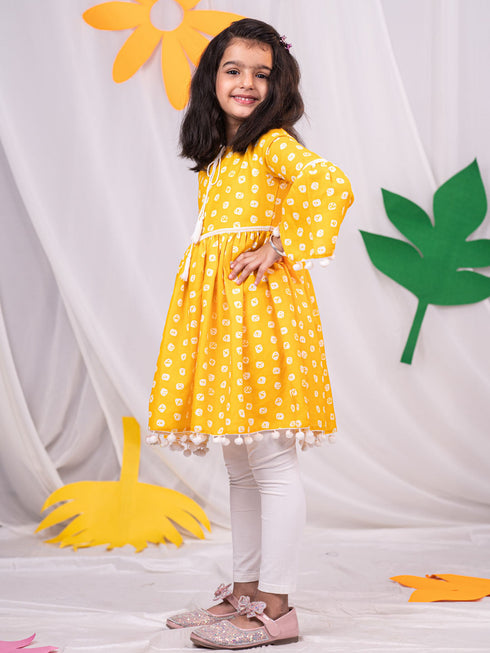 Vastramay Girl's Yellow Printed Ruffle Kurta With Leggings Set