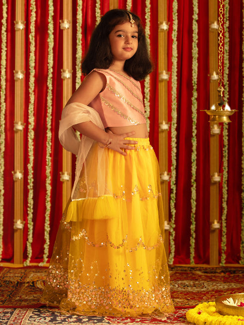 Vastramay Girls' Pink Crop Top And Yellow Net Lehenga With Ruffled Dupatta Set