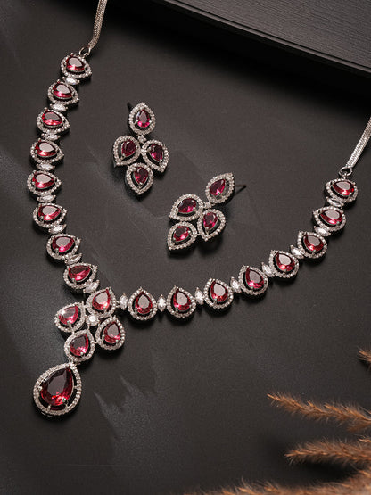 Silver toned necklace set with ruby red stones and AD.