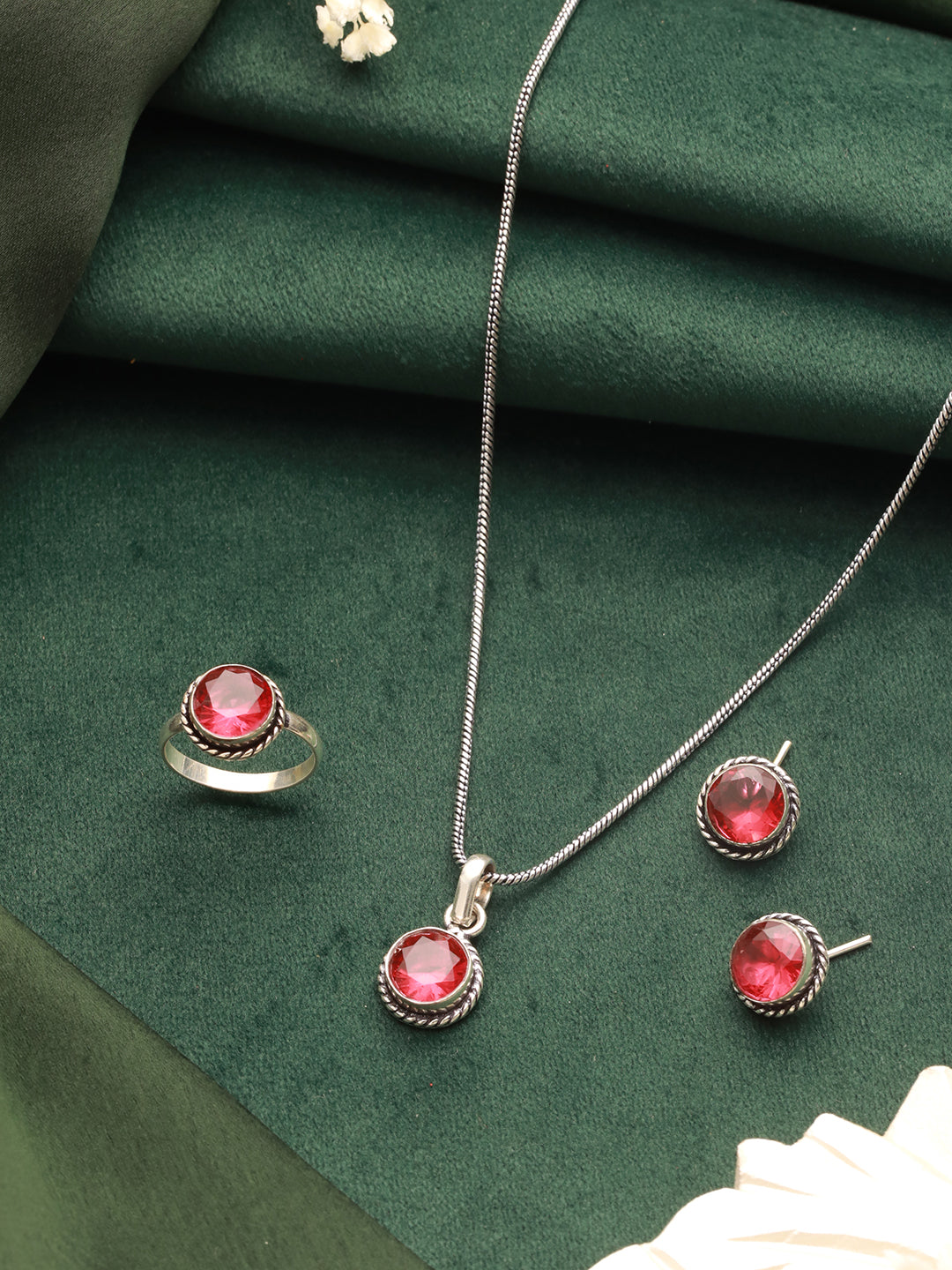 Silver locket pendant with red stone details