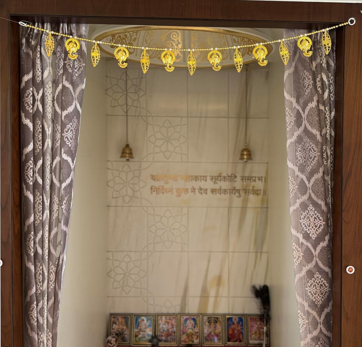 Toran hung at the entrance of a pooja room