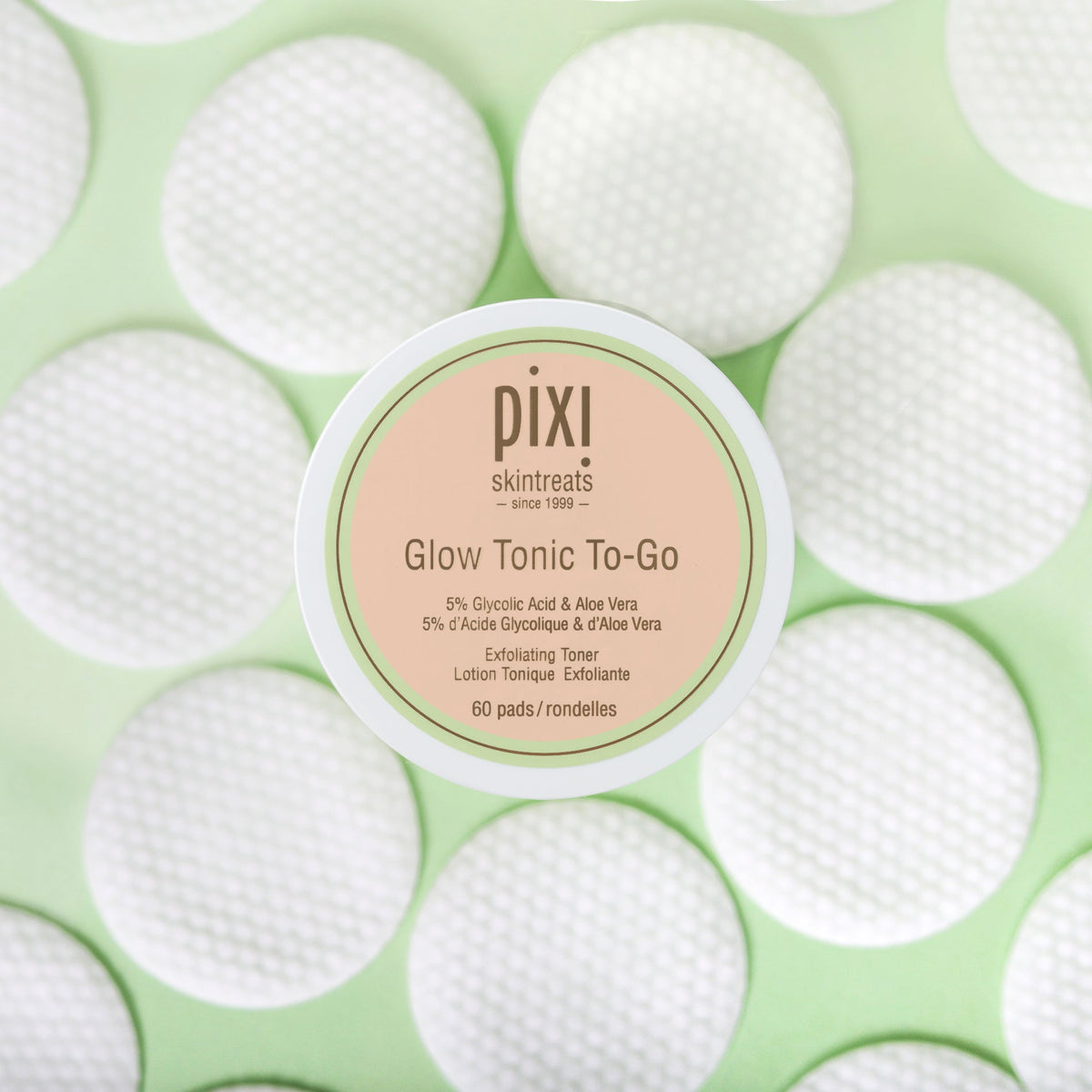 Close-up of a single Pixi Beauty Glow Tonic To Go pad, showcasing its texture and saturation.
