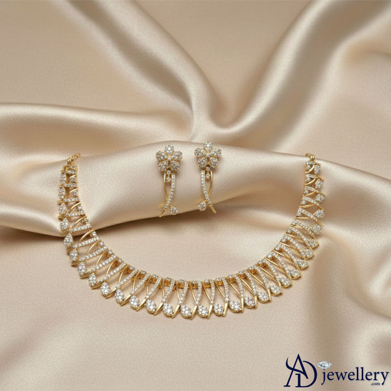 Gold-toned necklace with intricate leaf and feather design