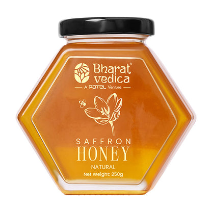 Bharat Vedica Saffron Honey in a signature hexagon bottle, showcasing its rich golden color with saffron strands.