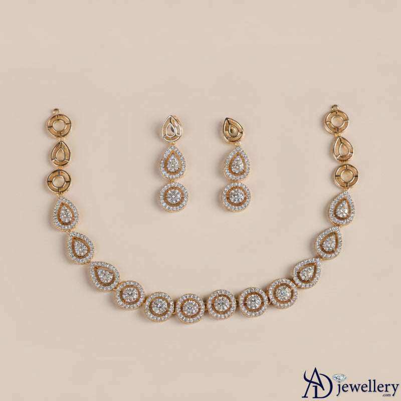 Matching gold-tone drop earrings with teardrop design