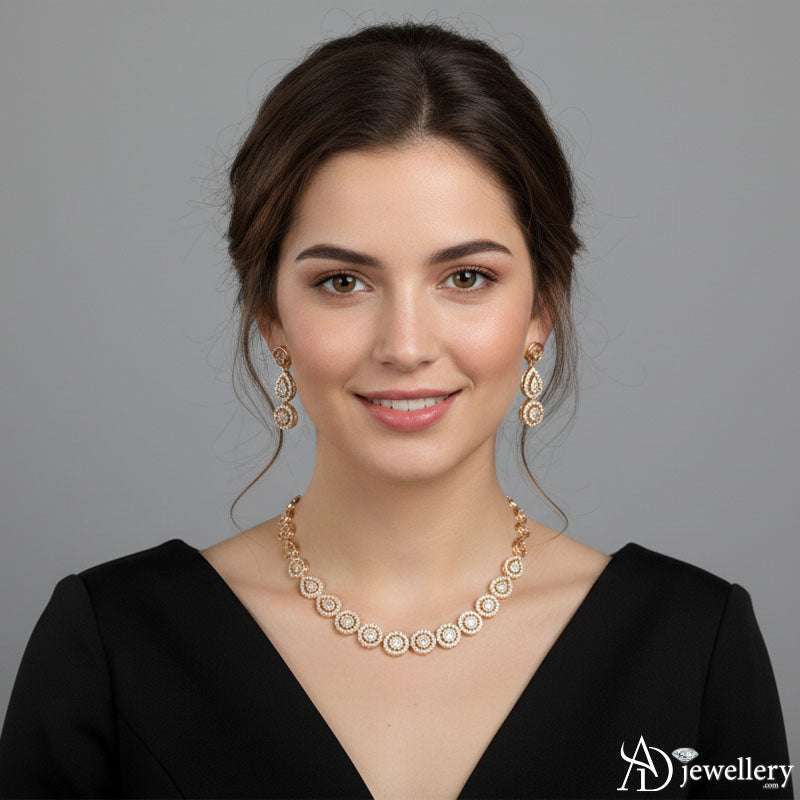 Gold-tone necklace with teardrop pendant and circular motifs