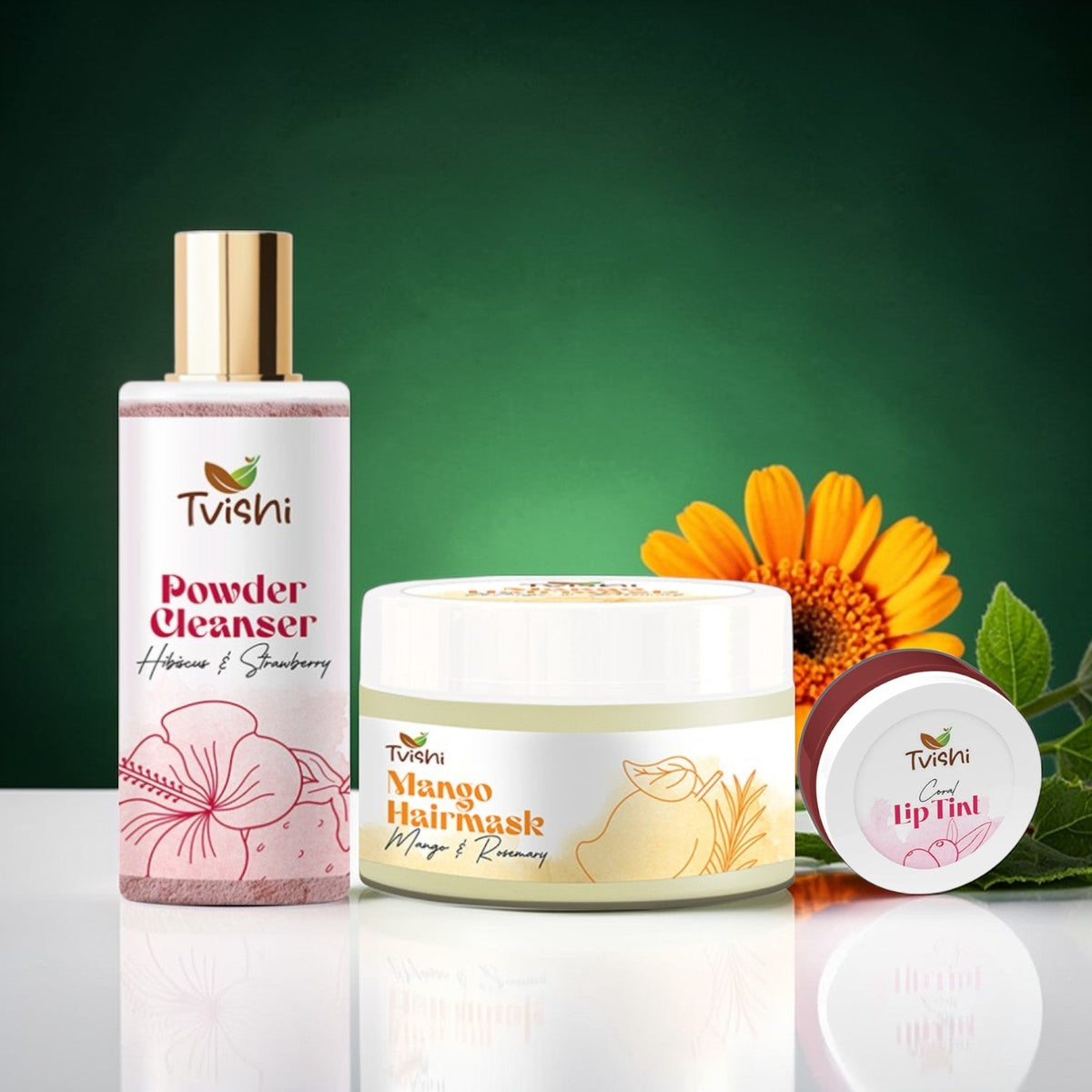 Tvishi Skincare Glow Starter Kit featuring Pink Powder Cleanser, Mango Hair Mask, and Coral Lip Tint.